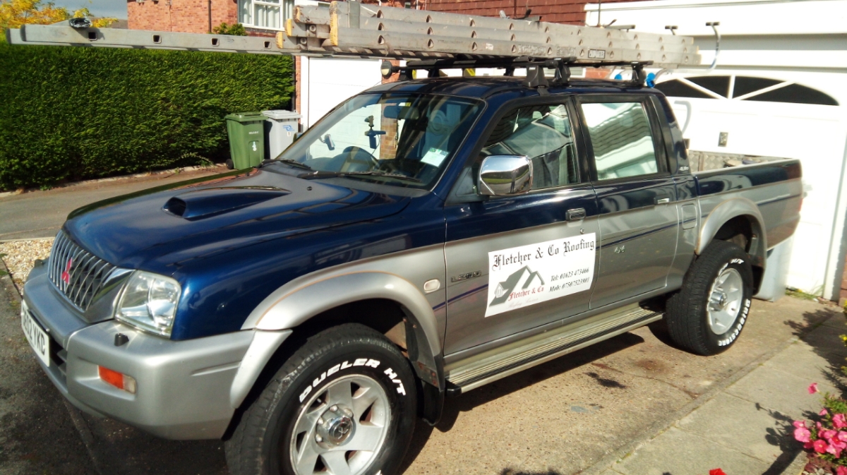The Fletcher & Co Roofing pickup truck, ladders loaded, outside a Rainworth home